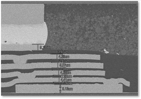 A grayscale microscopic image showing layered structures with various measurements indicated in micrometers.